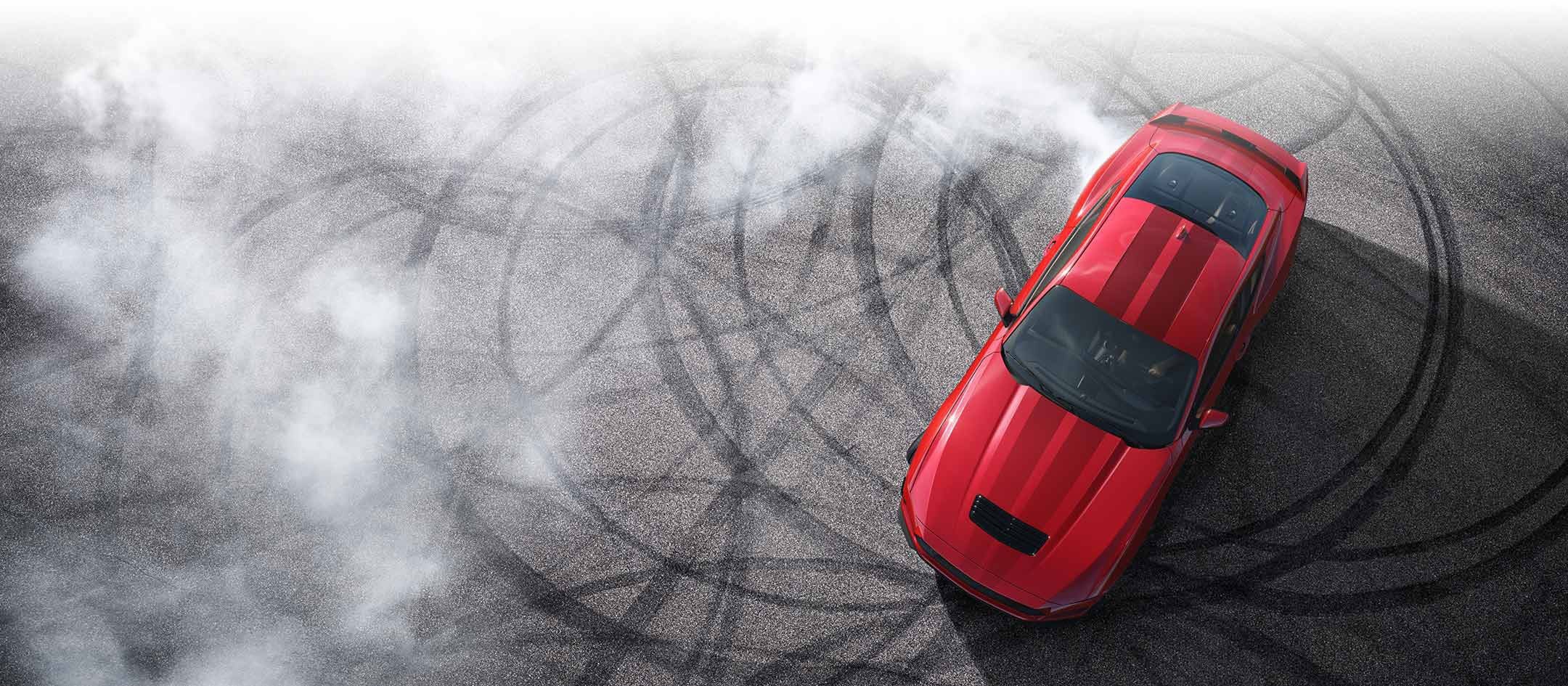 Overhead view of a 2024 Ford Mustang® model with tire tracks on pavement | Parks Ford of Wesley Chapel in Wesley Chapel FL