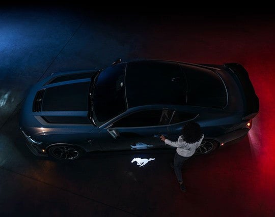 2024 Ford Mustang® Dark Horse™ model with a driver approaching the vehicle | Parks Ford of Wesley Chapel in Wesley Chapel FL